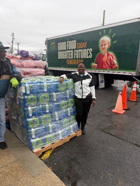 Ms. J supporting a community food distribution